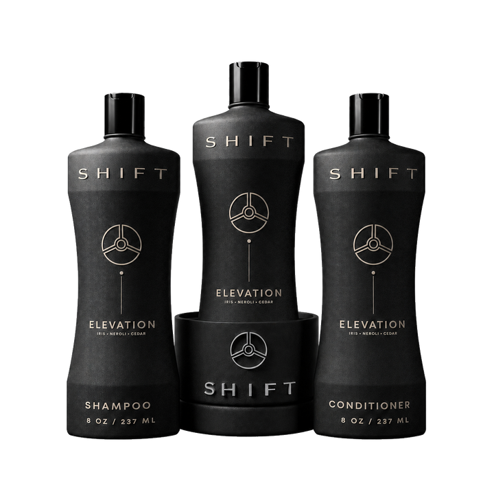 Elevation shampoo and conditioner beside a bottle seated in a SHIFT Base
